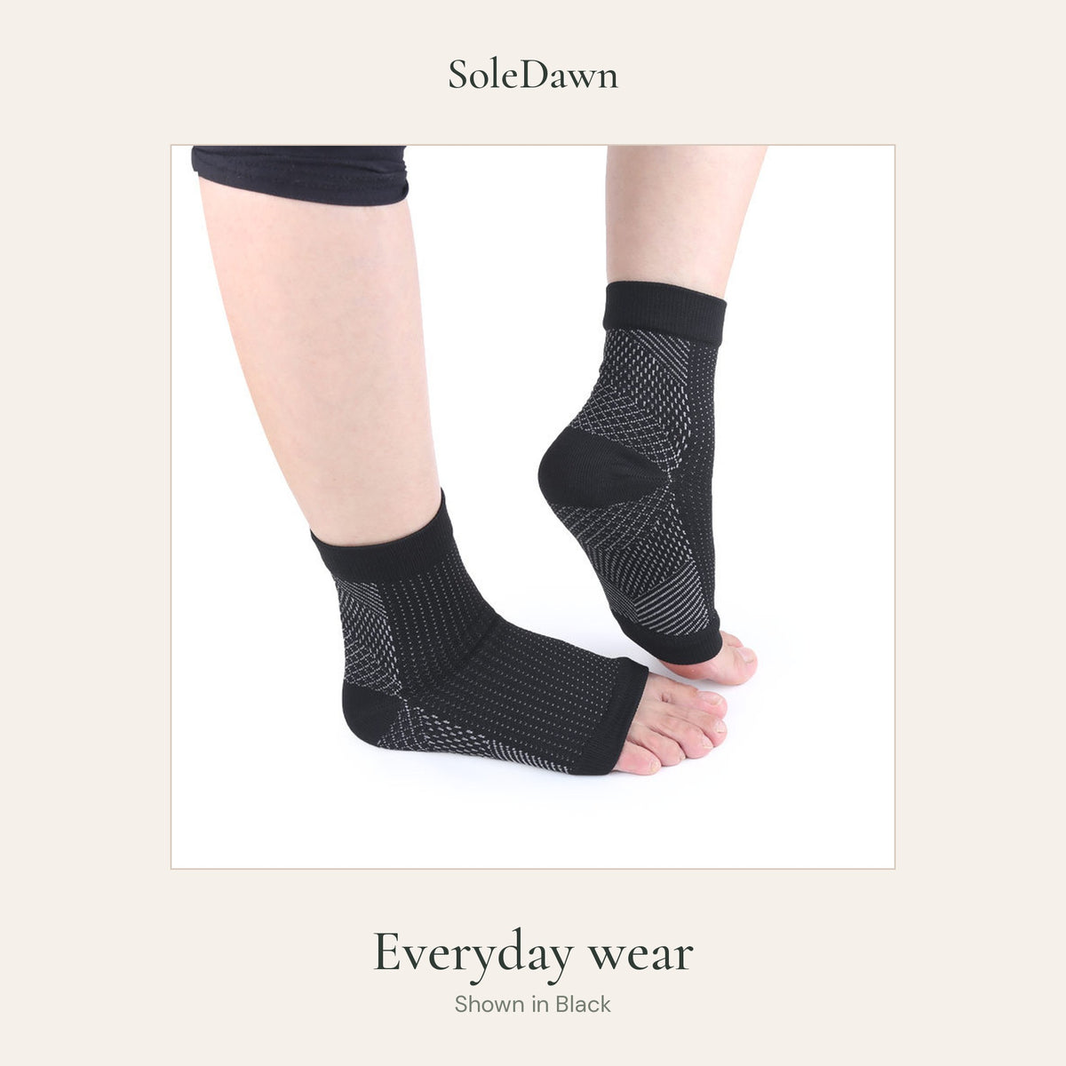 Two feet wearing black SoleDawn open-toe sleeves, lower-leg view